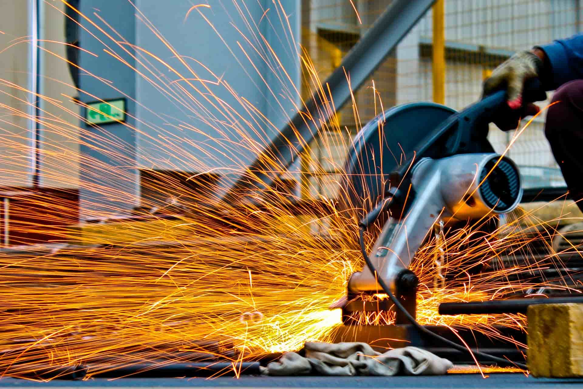 A cutting disc producing sparks while cutting metal.