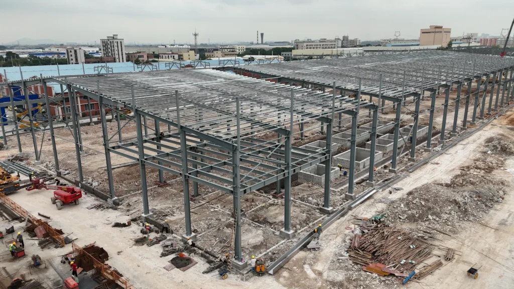Steel columns in industrial building supporting roof beams and wide-span warehouse frame