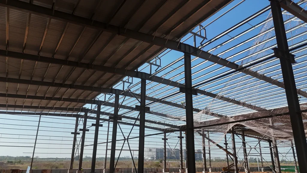 Large-span steel frame workshop interior with columns and bracing
