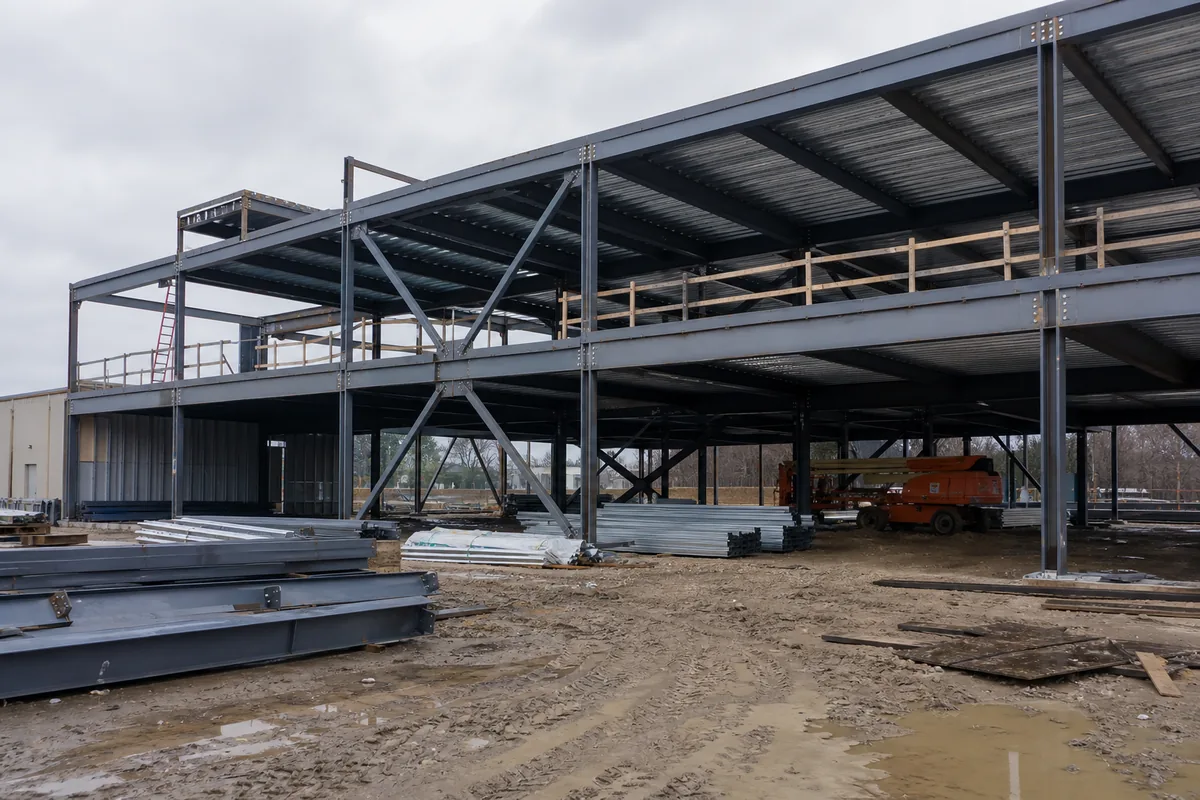 Two-story steel commercial building frame under construction without workers
