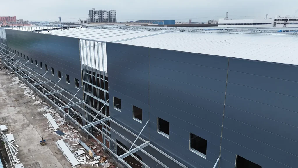 Roof and wall cladding system for a steel welding workshop building