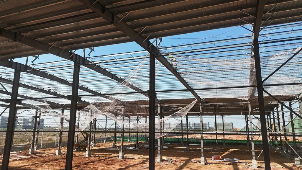 Roof purlins and safety net inside a steel structure workshop