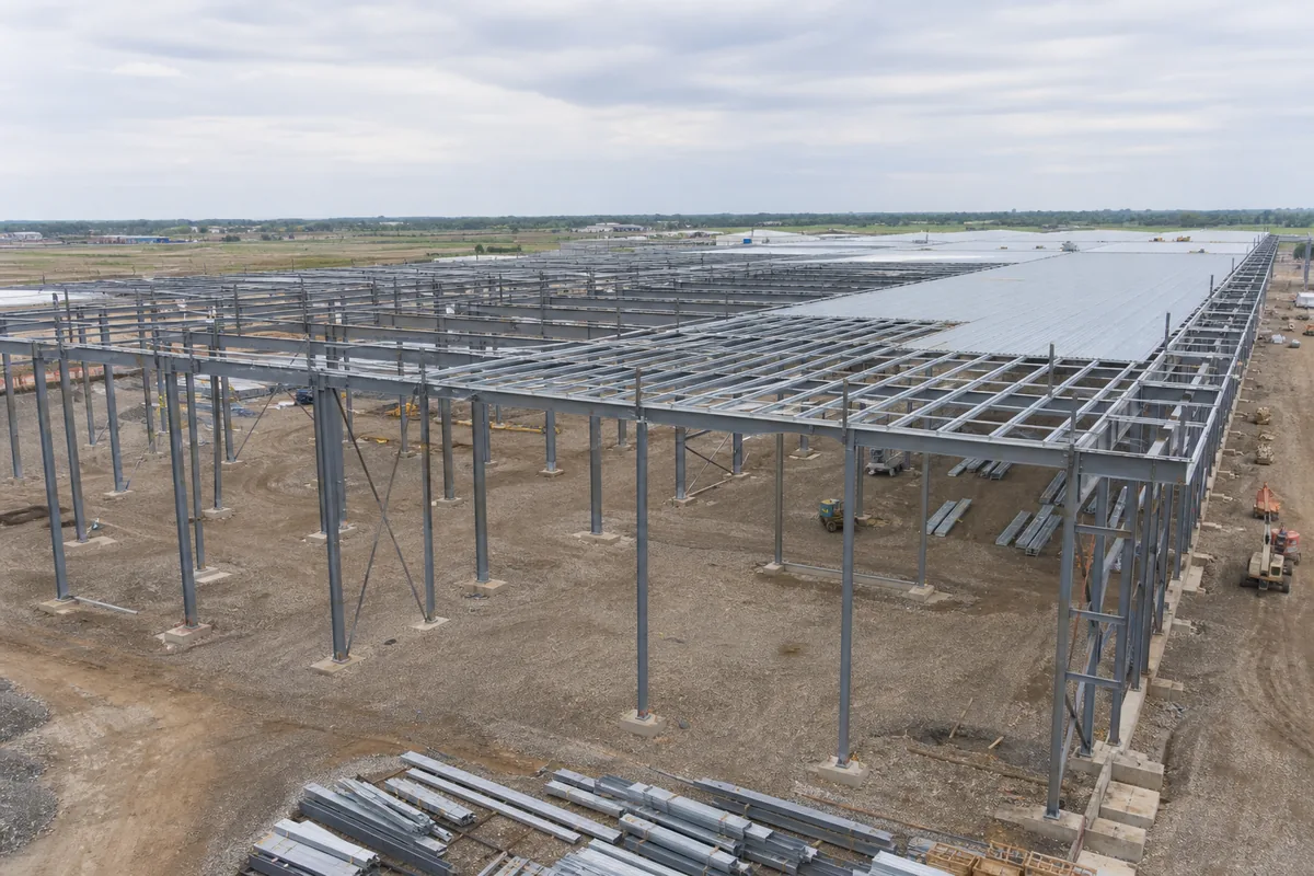 Wide multi-span industrial steel building frame under construction
